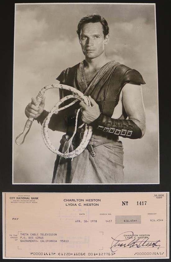 A photo of Charlton Heston with signed cashier cheque